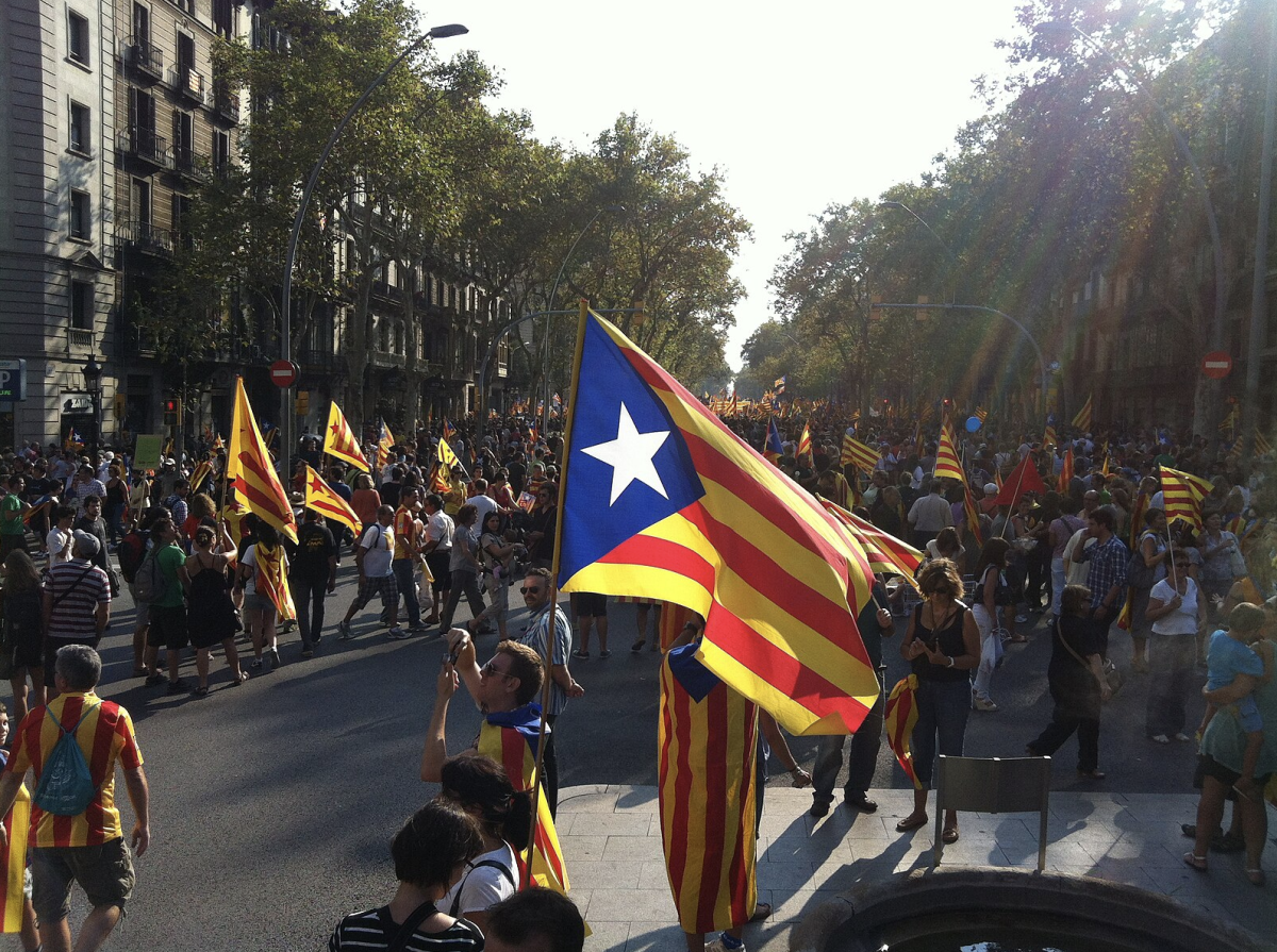 Catalan flags wave against the backdrop of Barcelonas bustling streets, as the quest for independence continues to shape the regions political landscape.
(Photo Credit: Kippelboy, CC BY-SA 3.0 , via Wikimedia Commons)